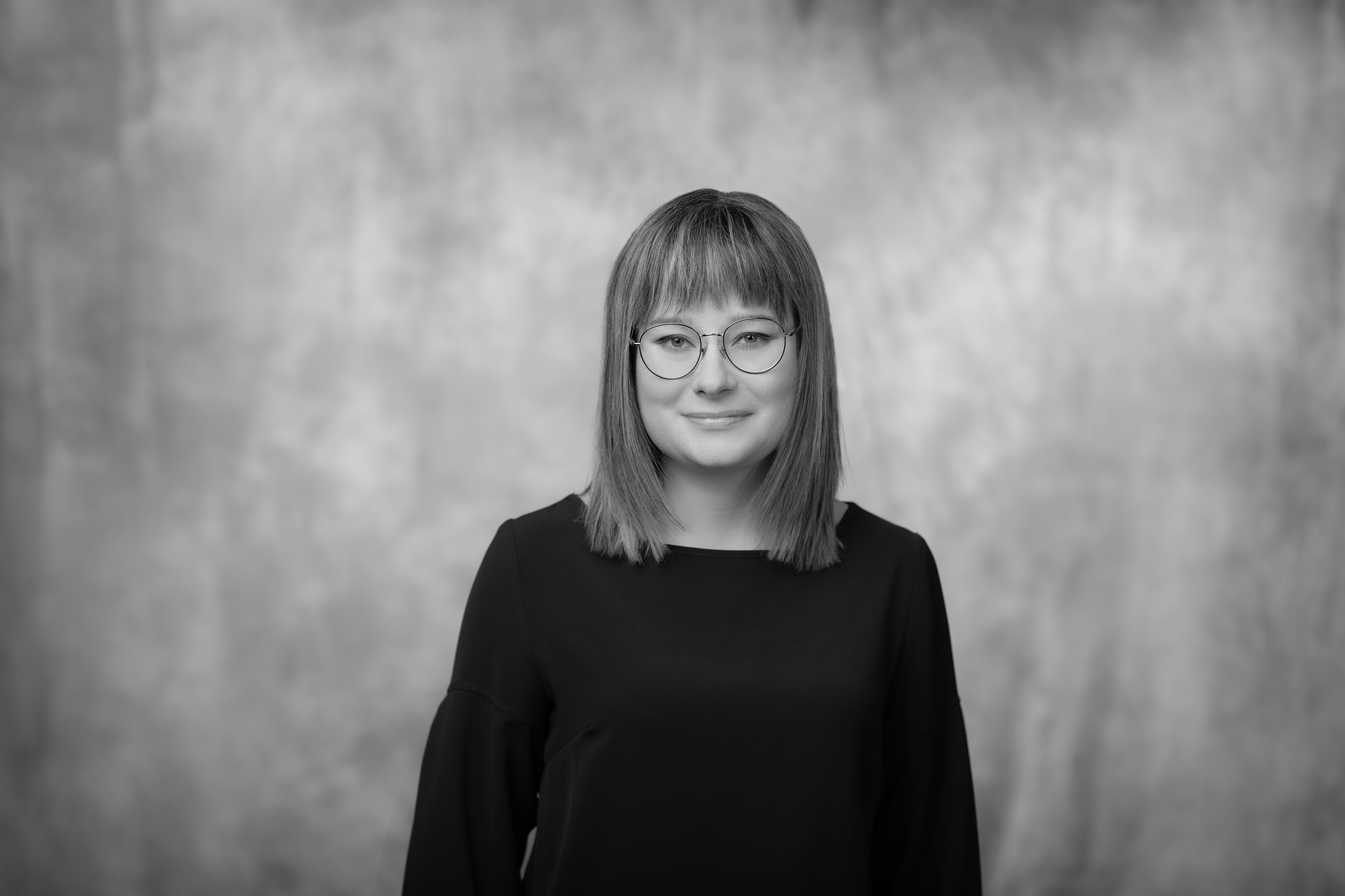 portret młodej uśmiechniętej kobiety w okularach