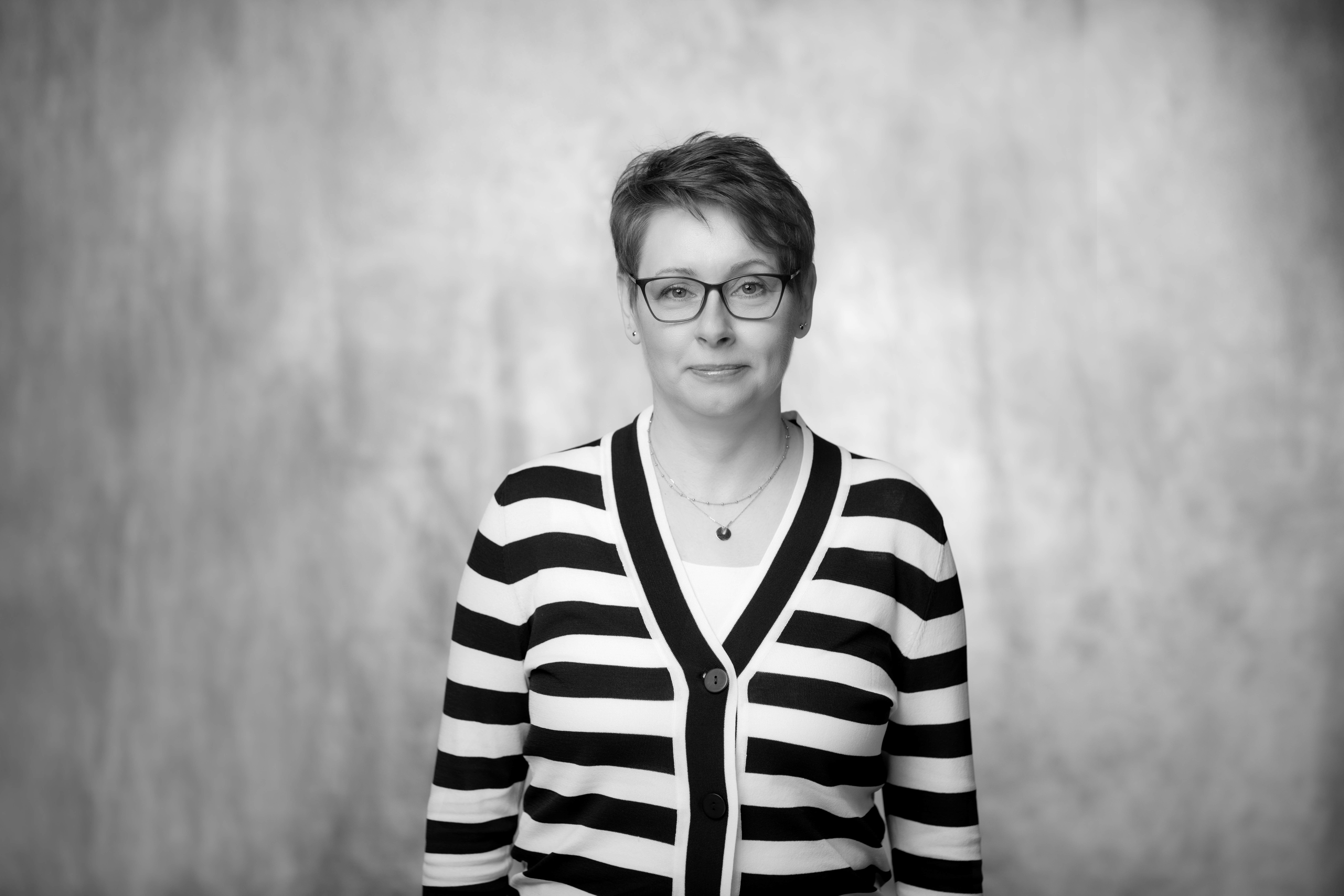 czarnobiałe zdjęcie portretowe dojrzałej kobiety, w swetrze w paski, i