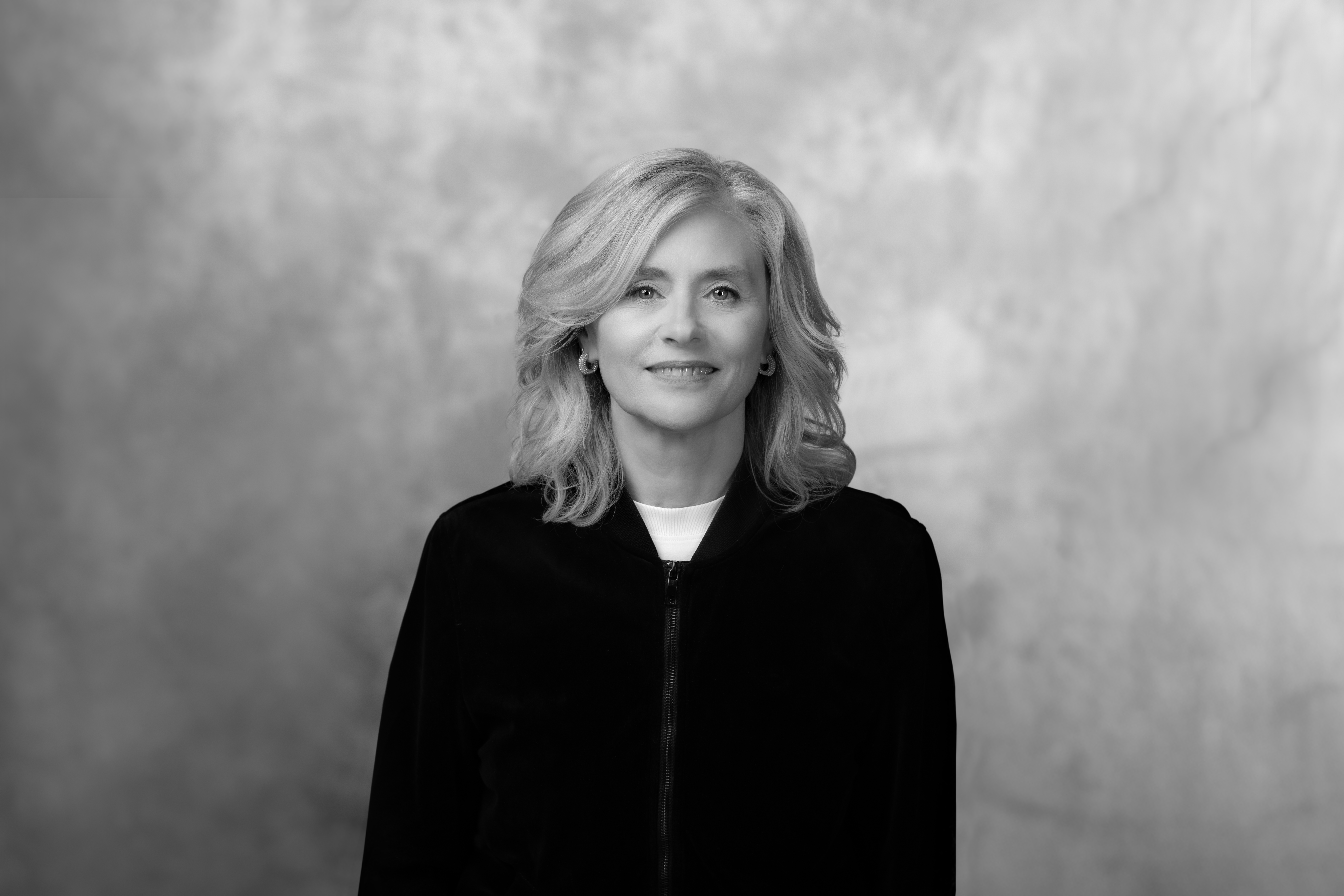 czarnobiałe zdjęcie portretowe eleganckiej kobiety w ciemnych włosach i ciemnym żakiecie